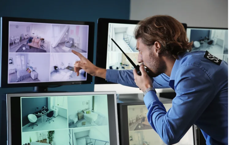 security guard monitoring modern cctv cameras surveillance room